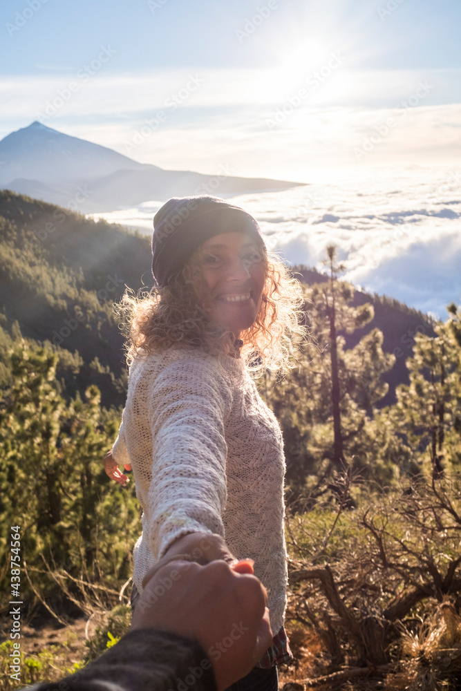 Happy woman smile and have fun outdoor with her boyfriend together at the mountain - pov of holding hands and love couple enjoying time in travel vacation or weekend