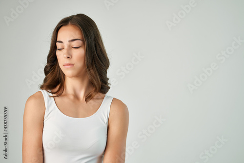 woman in white t shirt emotion displeased facial expression studio isolated background