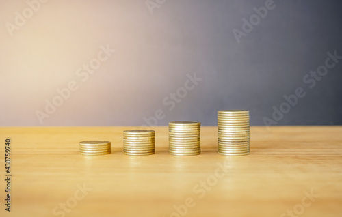 stack of coins on the table with gray background