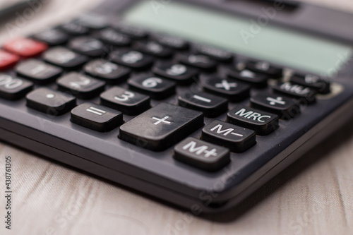 Black calculator on texture background stock image.