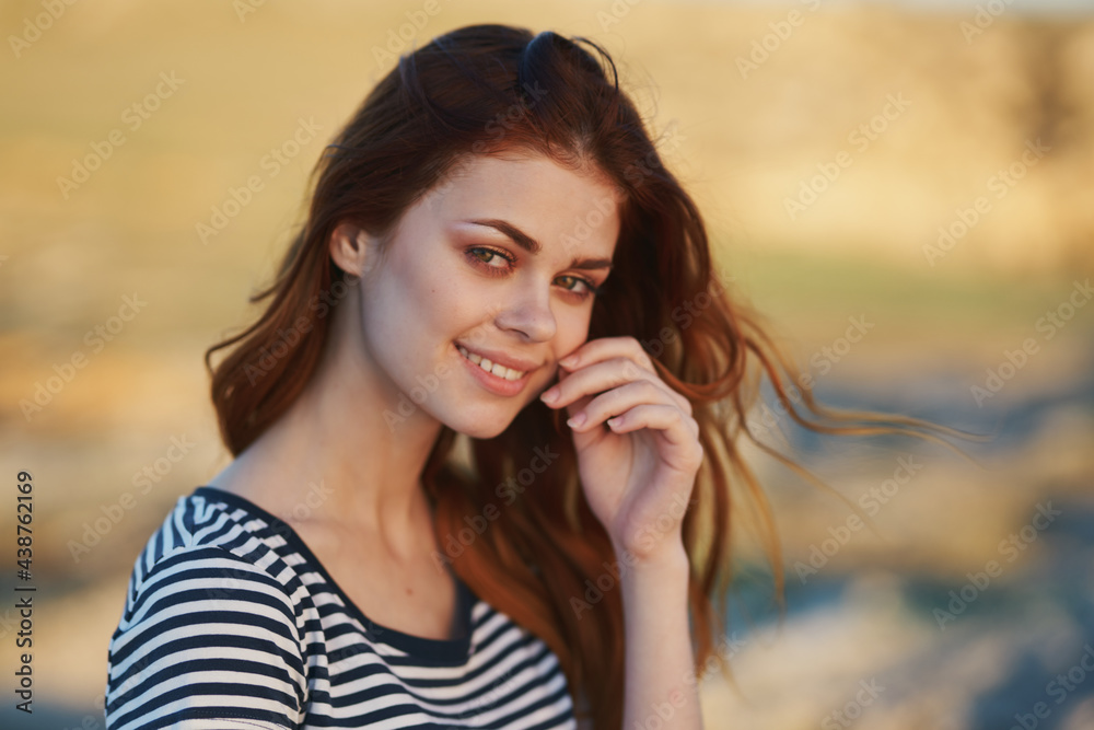 happy red-haired woman outdoors in the mountains smile model hairstyle