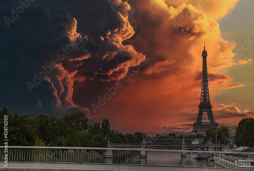 Dramatic sunset sky - Beautiful view of the famous Eiffel Tower in Paris, France. The best Paris destinations in Europe. Storm montage over the Eiffel Tower in Paris (not real)