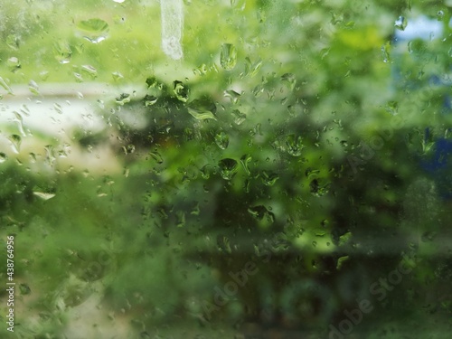 The raindrops sit on the glass after the rain.