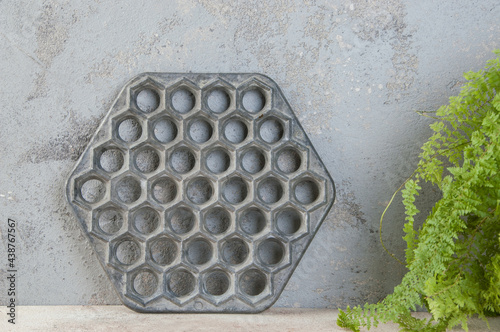 Old aluminum dumplings mold on concrete background.