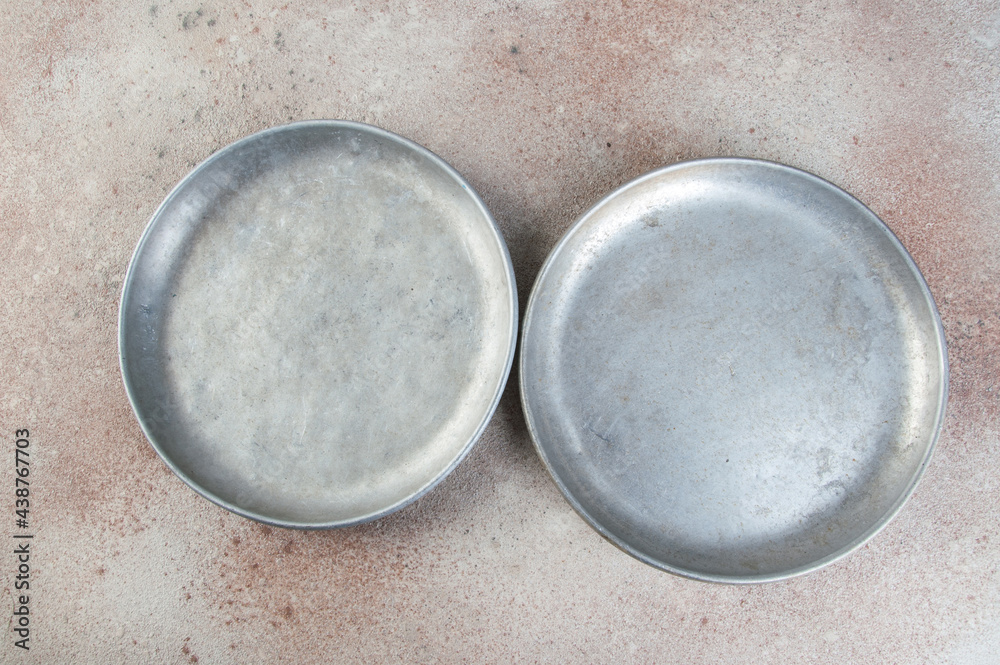 Old metal plates for scales on concrete background. Old metal plates for scales on concrete background.