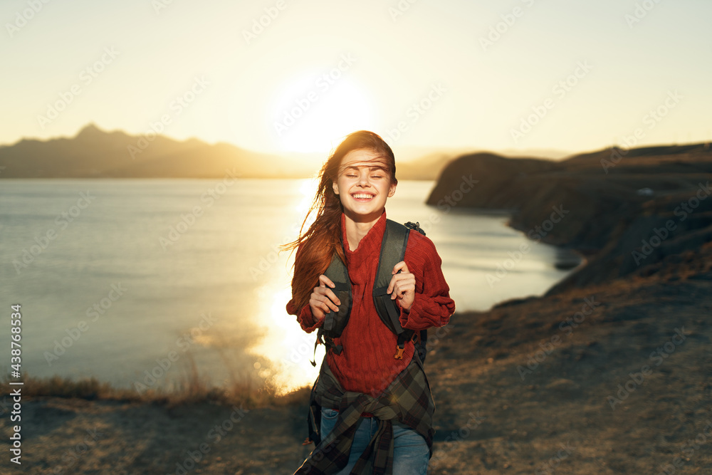 cheerful woman hiker with a backpack outdoors freedom travel vacation