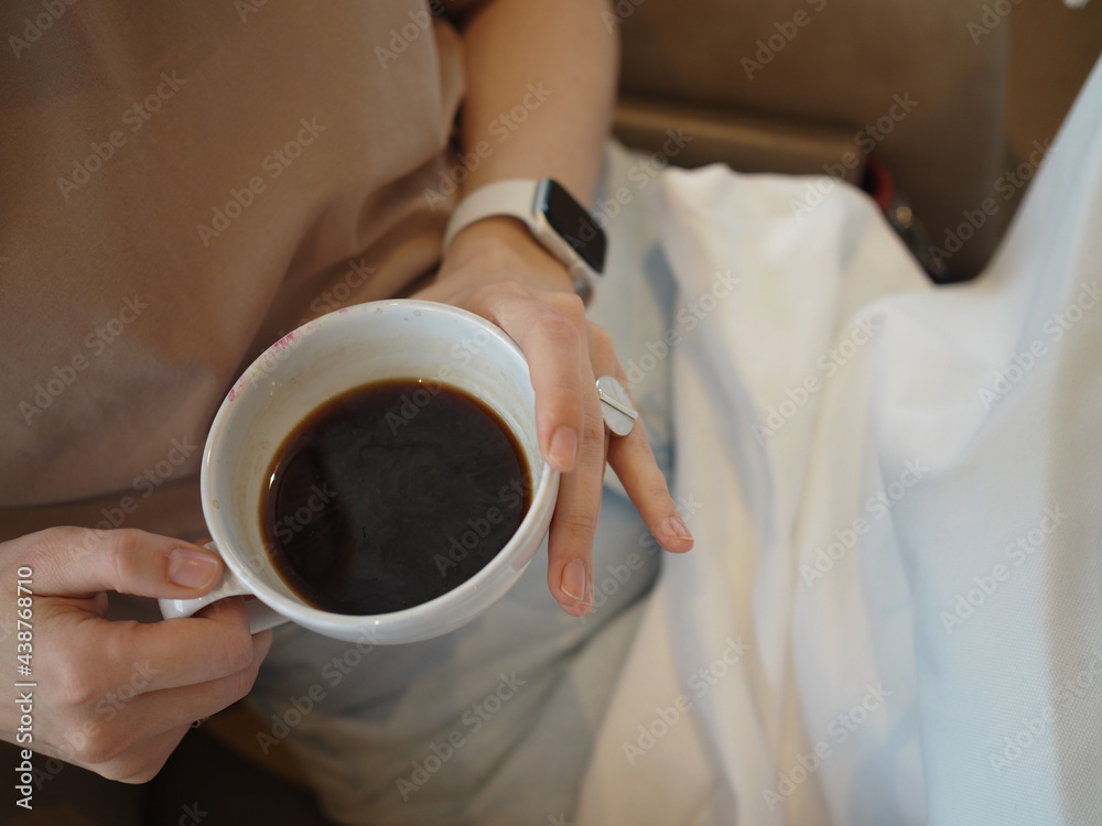 young beautiful woman eats in a restaurant, drinks a cocktail, coffee, jewelry on her hands, stylishly dressed young beautiful woman eats in a restaurant, drinks a cocktail, coffee, jewelry on her hands, stylishly dressed