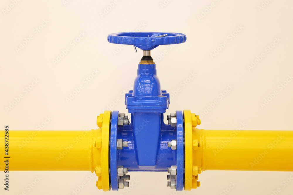 Pipeline with valve. Yellow tube with blue crane, oil and gas industry Pipeline with valve. Yellow tube with blue crane, oil and gas industry