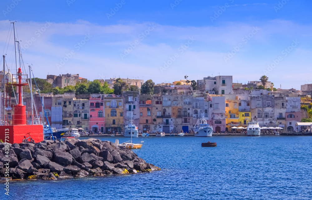 Panoramic view of Procida, Italian Capital of Culture 2022: colorful houses, cafes and restaurants, fishing boats and yachts in Marina Grande , in Gulf of Naples, Campania, Italy.	
