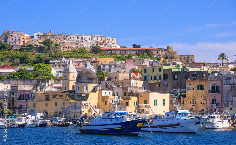 Panoramic view of Procida, Italian Capital of Culture 2022: colorful houses, cafes and restaurants, fishing boats and yachts in Marina Grande , in Gulf of Naples, Campania, Italy.	