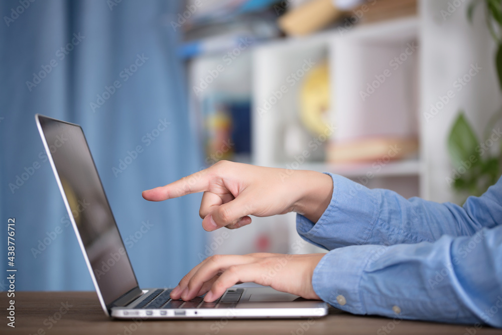 Fototapeta premium Man using laptop to work indoors