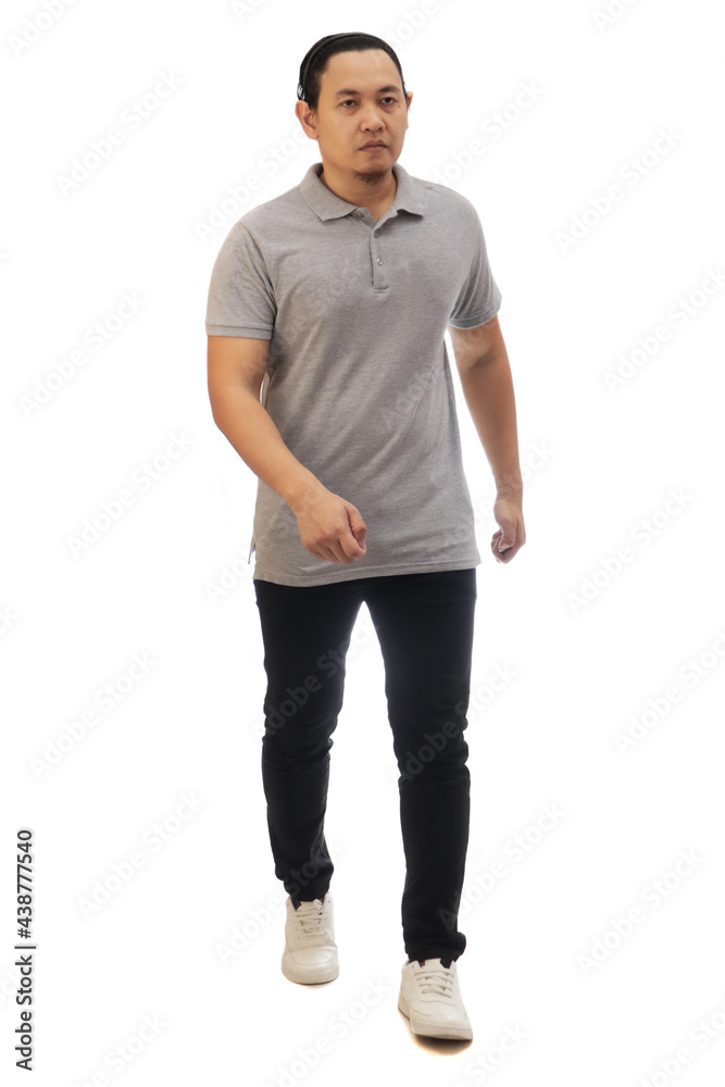 Asian man wearing grey shirt black denim and white shoes, walking forward, side view, happy confidence expression. Full body portrait isolated Asian man wearing grey shirt black denim and white shoes, walking forward, side view, happy confidence expression. Full body portrait isolated
