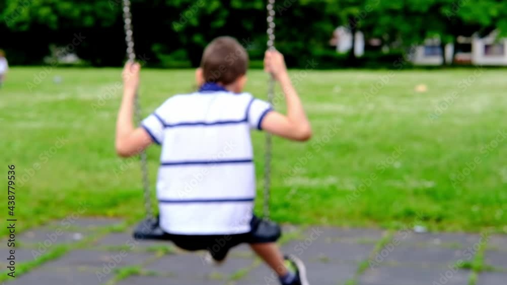 blurred image, boy 8-10 years old swinging on a swing, walk in the park in the park, happy childhood concept, active people blurred image, boy 8-10 years old swinging on a swing, walk in the park in the park, happy childhood concept, active people