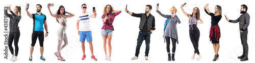 Group of active sporty and stylish hipster people taking selfies with cell phone full body isolated on white background.  photo