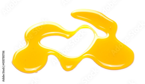 Honey puddle in heart shape isolated on white background