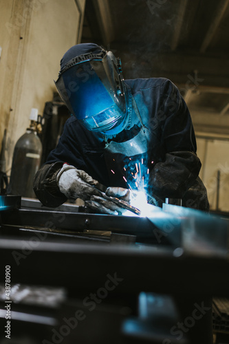 Manual worker welder on his job. People at heavy industry work. © Dusko