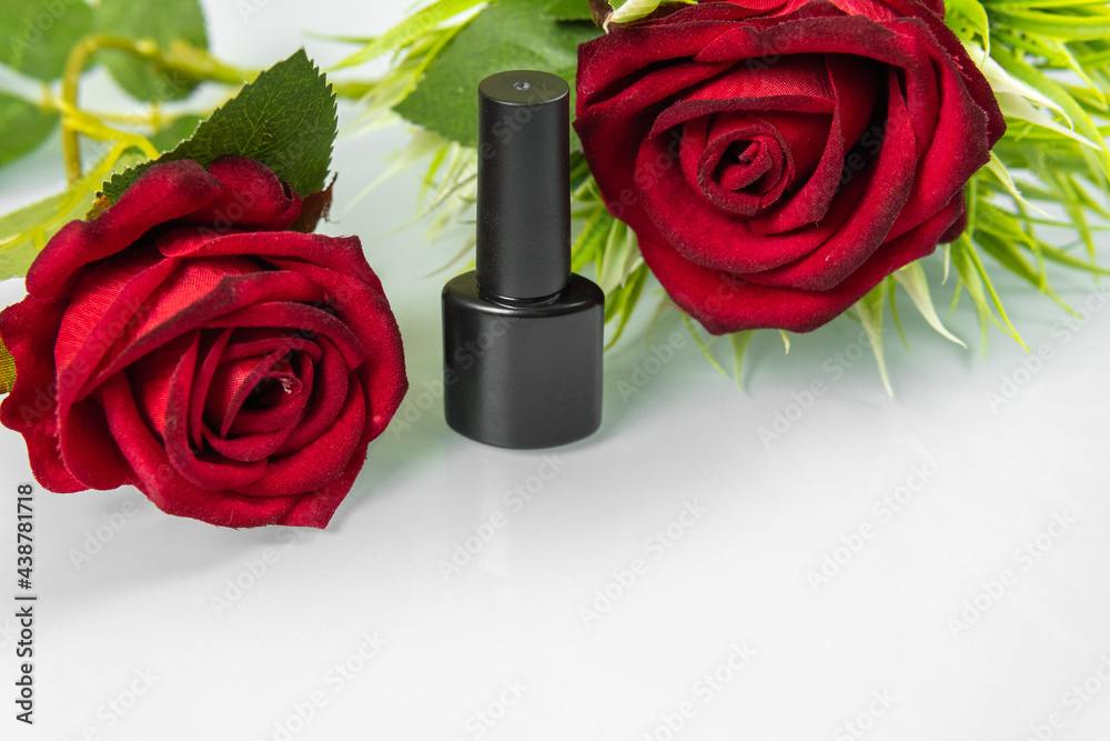 Nail polish with red roses on a light background. High quality photo Nail polish with red roses on a light background. High quality photo