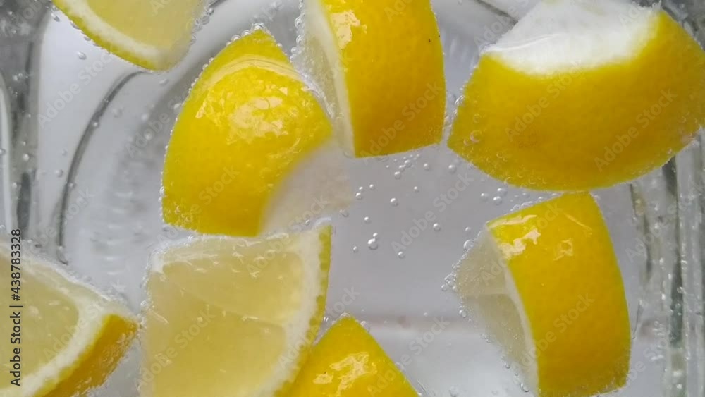 Macro shot of lemon with tiny air bubbles forming in soda water
