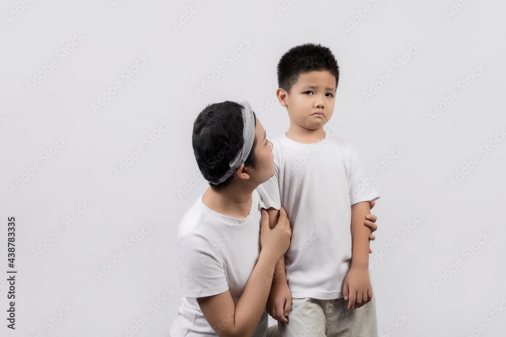 Young adult female cancer patient spending time with little son on gray background. Cancer and family support concept. Young adult female cancer patient spending time with little son on gray background. Cancer and family support concept.