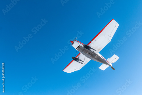 Propeller airplane overflying deep blue sky