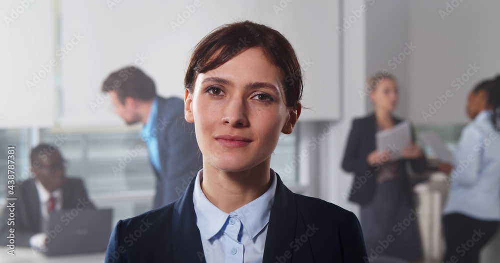 Portrait of young businesswoman in busy modern workplace Portrait of young businesswoman in busy modern workplace