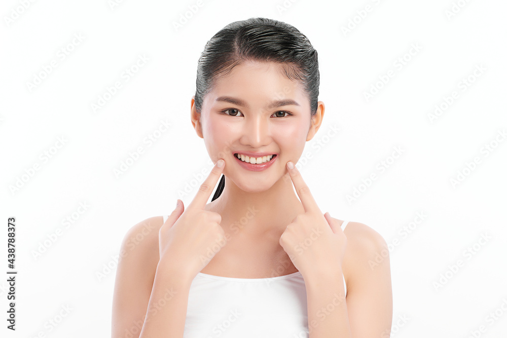 beautiful young asian woman pointing to beautiful teeth on white background, beautiful young asian woman pointing to beautiful teeth on white background,