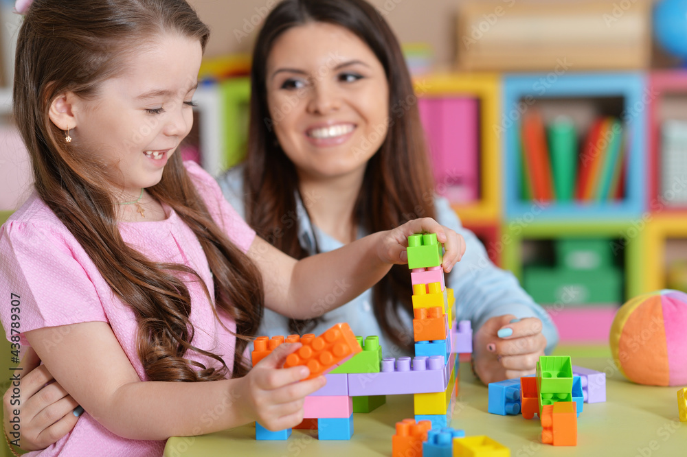 Cute little girl and her mother playing Cute little girl and her mother playing