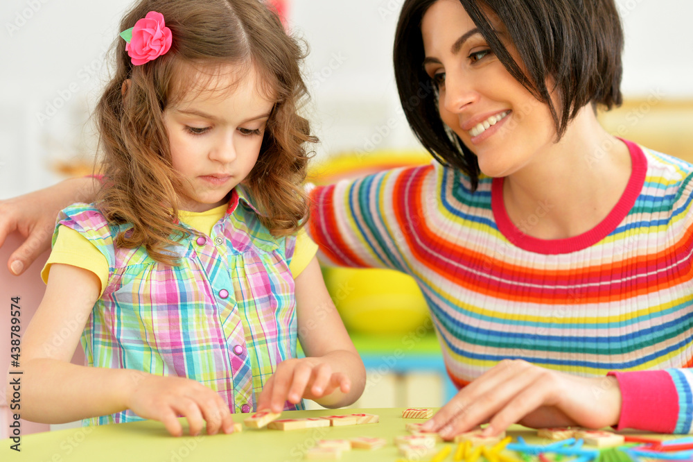 Cute little girl with her mother studying Cute little girl with her mother studying
