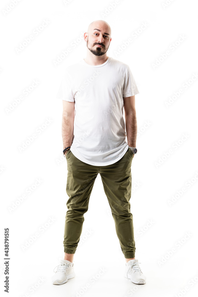 Funny skeptical young bearded bald man with pessimistic raised eyebrows expression. Full body length isolated on white background Funny skeptical young bearded bald man with pessimistic raised eyebrows expression. Full body length isolated on white background