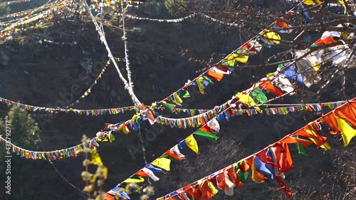 Close-up slow motion shot of the Colorful Buddhist Bhutanese Tibetan prayer flag covering the mountains at Pangan Nyingma Monastery in Patlikuhal village near Manali, Himachal Pradesh, India