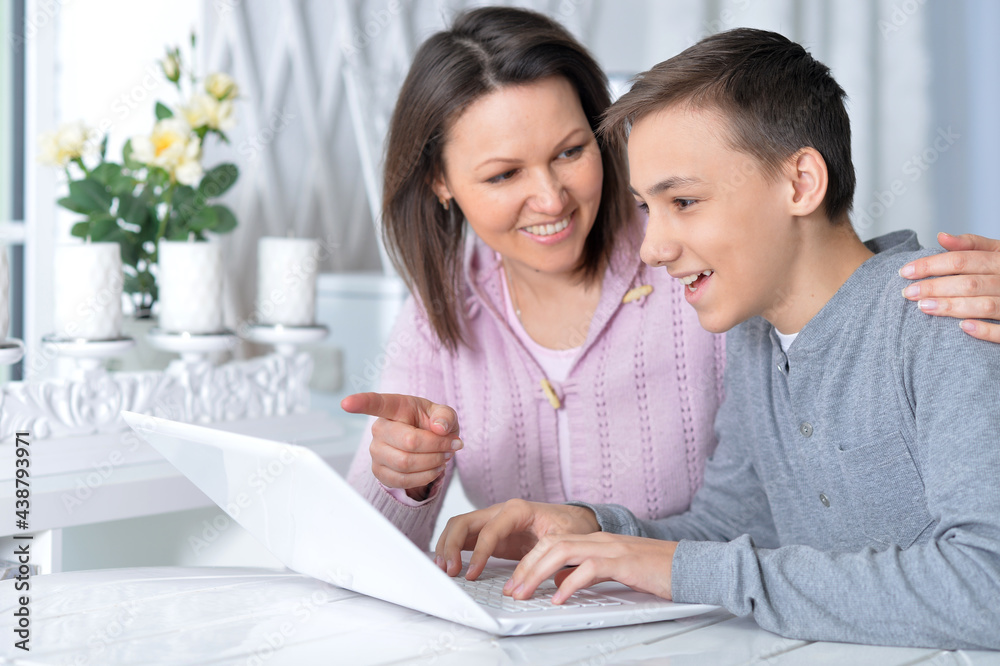 Emotional mother and son using modern laptop Emotional mother and son using modern laptop