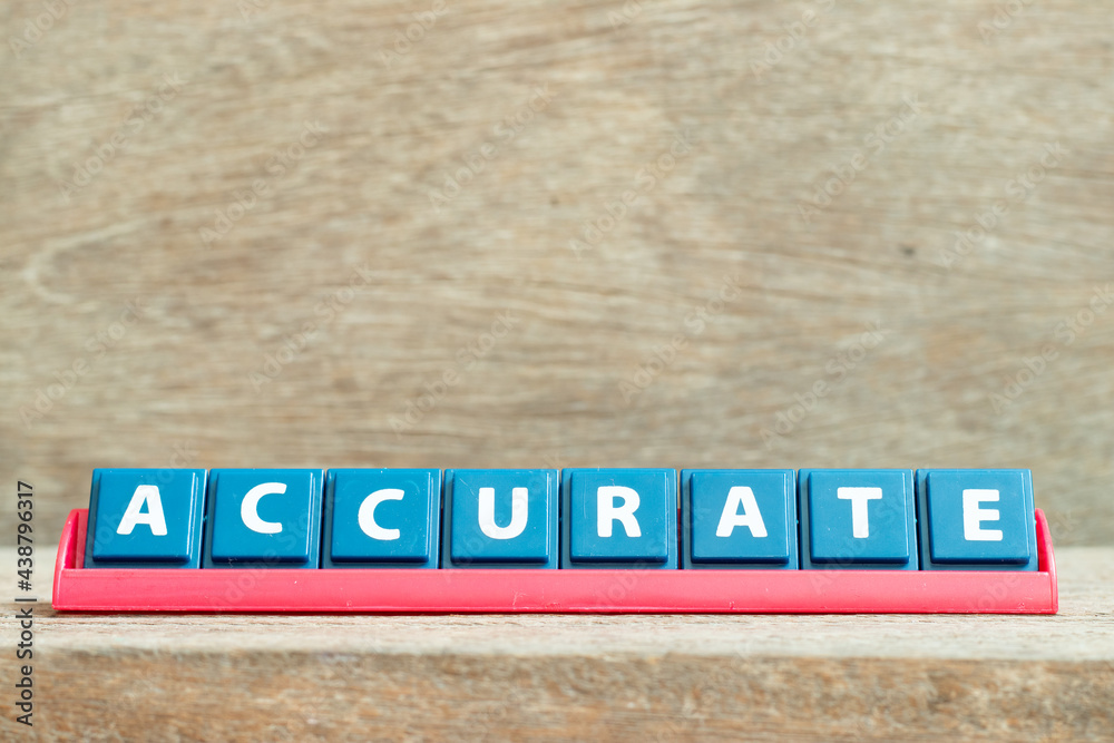 Tile alphabet letter with word accurate in red color rack on wood background Tile alphabet letter with word accurate in red color rack on wood background