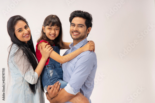 PORTRAIT OF A HAPPY FAMILY POSING IN FRONT OF CAMERA	