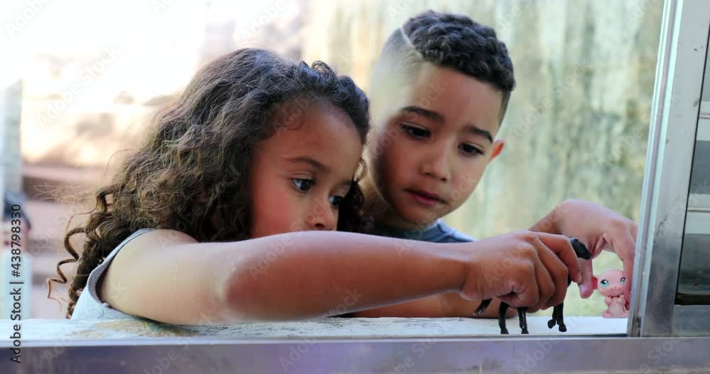 Little kids playing with toys. Small siblings play with toy. Hispanic latin children