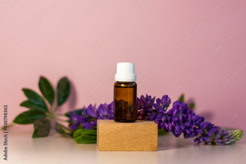Bottle without label with oil on the stand. Transparent glass container with a dispenser on a beige-pink background. Product banner. Space for text, design. Bottle without label with oil on the stand. Transparent glass container with a dispenser on a beige-pink background. Product banner. Space for text, design.