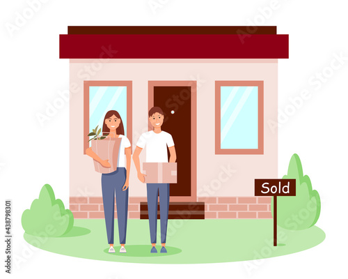 A happy young family bought a new home. A man and a woman are standing with boxes near their house. Home buying concept. Cartoon vector illustration.