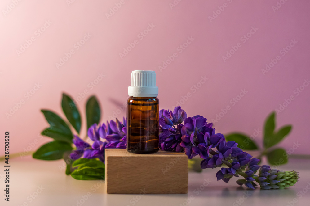 Bottle without label with oil on the stand. Transparent glass container with a dispenser on a beige-pink background. Product banner. Space for text, design. Bottle without label with oil on the stand. Transparent glass container with a dispenser on a beige-pink background. Product banner. Space for text, design.