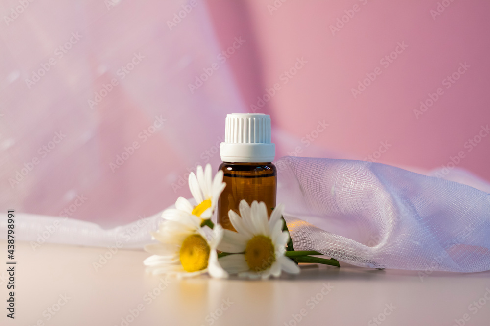 A bottle without an oil label. Transparent glass bottle on a beige-pink background. Natural cosmetic product. Product banner. Space for text and design. A bottle without an oil label. Transparent glass bottle on a beige-pink background. Natural cosmetic product. Product banner. Space for text and design.