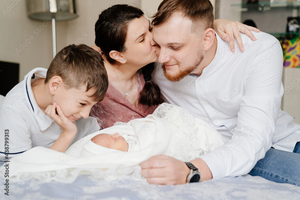 the first day of the newborn at home. Happy family with a toddler in the bedroom