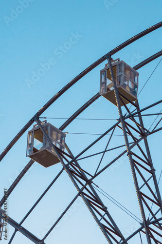 Ferris wheel cabins against the background of the evening blue sky
