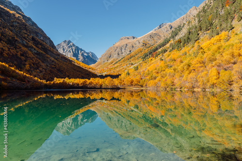 Fototapeta Naklejka Na Ścianę i Meble -  Mountain lake with crystal water, reflection and autumnal trees.