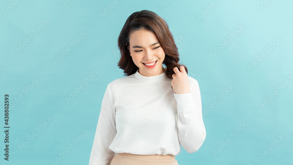 Portrait of tender smiling woman gently touching face and blushing, looking away coquettish Portrait of tender smiling woman gently touching face and blushing, looking away coquettish