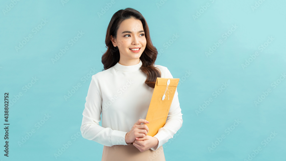 Beautiful Business Woman reading paper on blue background Beautiful Business Woman reading paper on blue background