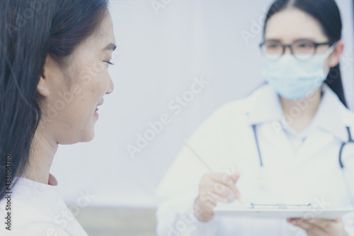 Female doctor holding back to treat patient