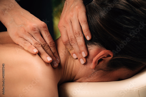 Massaging Woman’s Neck. Deep Tissue Massage. © Microgen