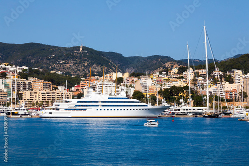 Fotografie View of the bay of Palma de Mallorca with luxury yachts, buildings, mountains and beautiful clouds