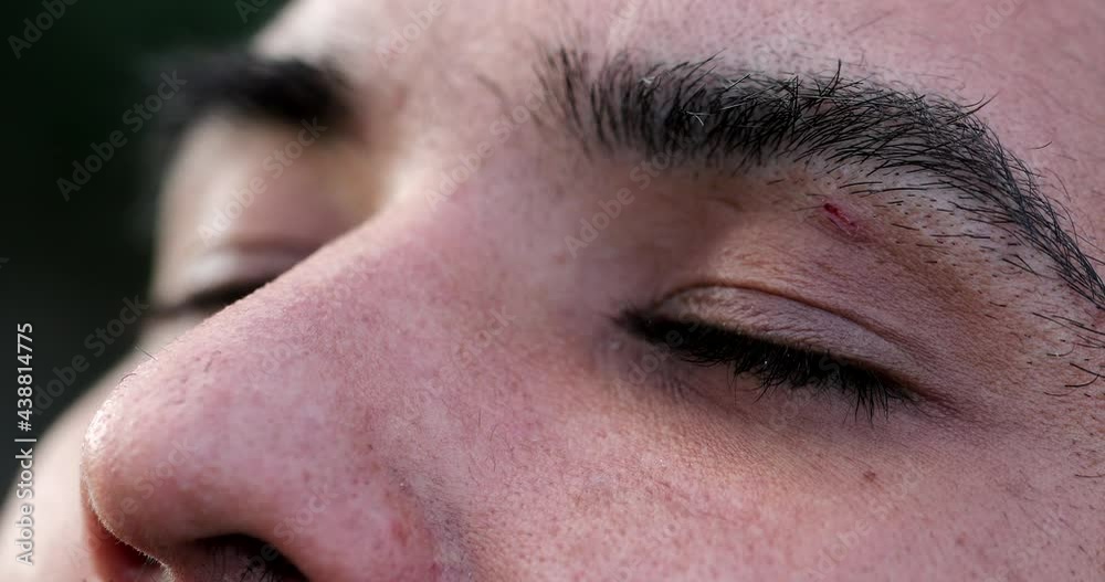 Young man close-up eyes in contemplation and meditation having faith and trust Young man close-up eyes in contemplation and meditation having faith and trust