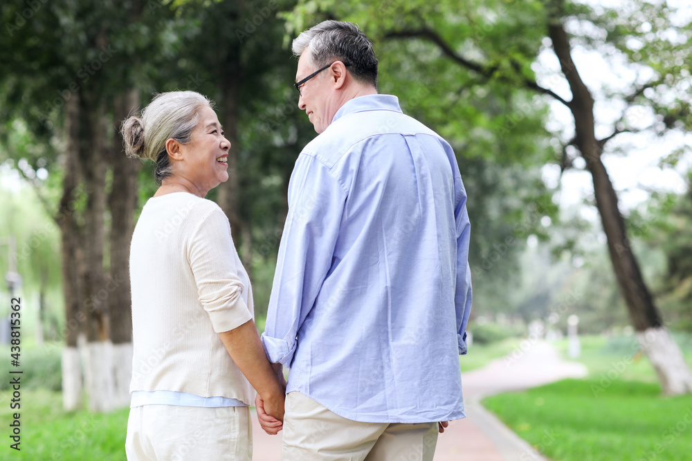 Happy old couple walking in the park Happy old couple walking in the park