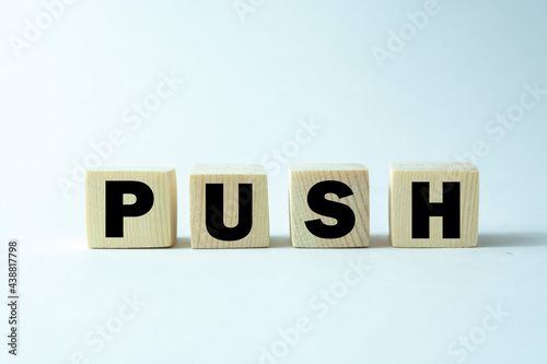 Time to push. Wooden block form the word 'push' on beautiful white background. Business and push concept. Copy space.
