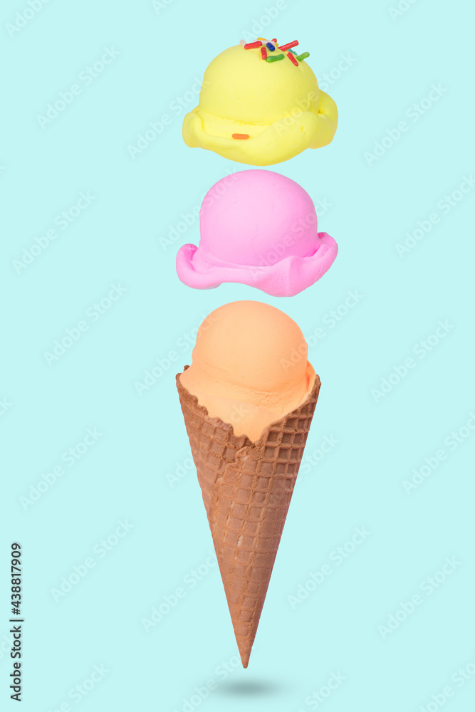 Creative idea made of Ice cream cone with floating colorful ice cream scoops on pastel blue background. Creative idea made of Ice cream cone with floating colorful ice cream scoops on pastel blue background.